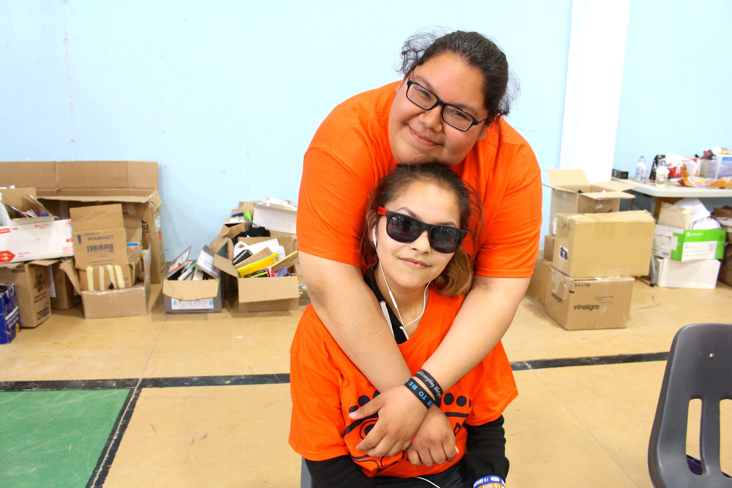 Keisha and Janelle organize donations for distribution to the community.