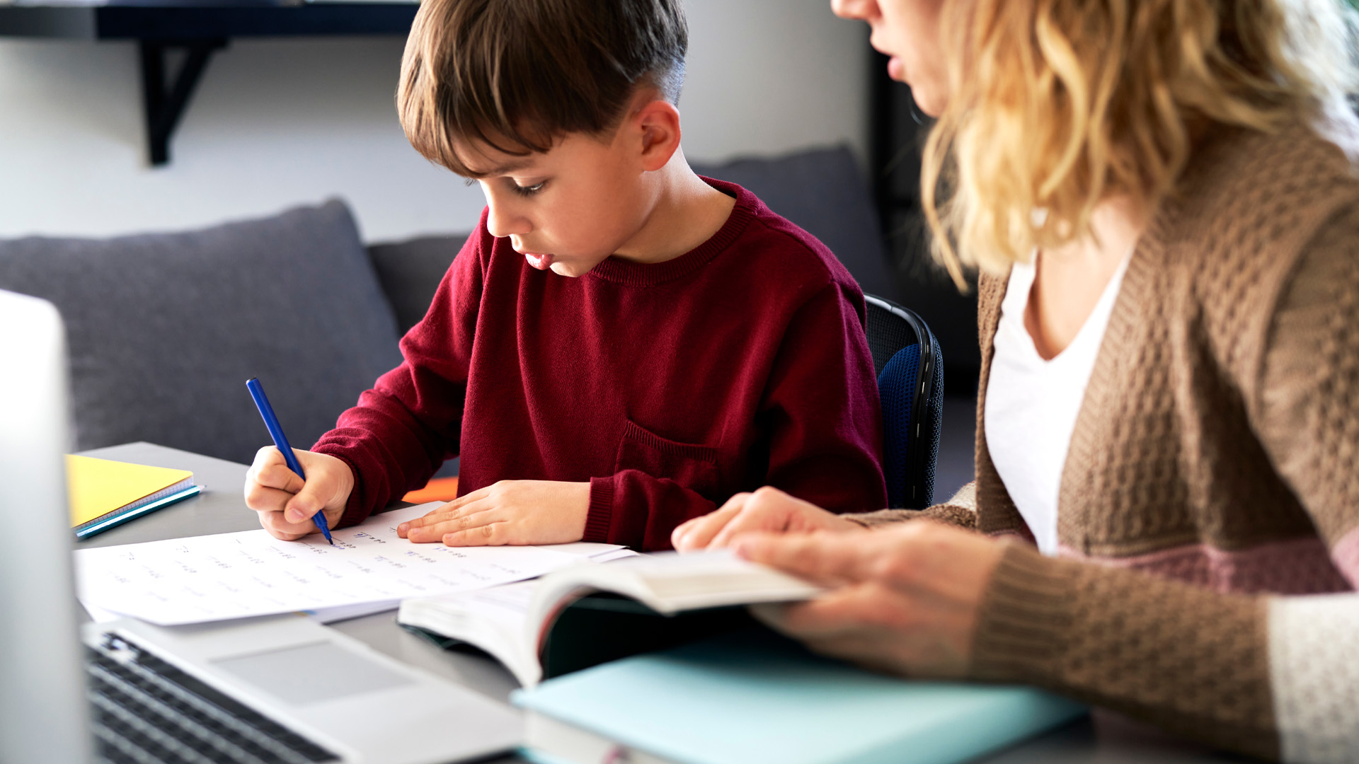 Young boy gets help with homework.