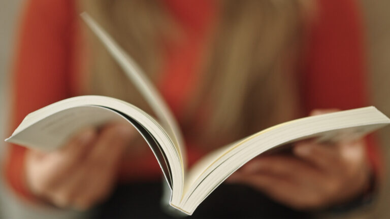 Hands holding a book.