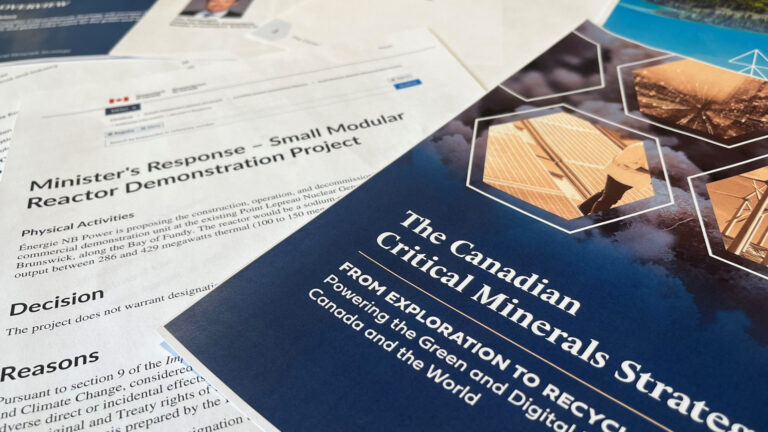 Printed promotional materials for the federal government’s Critical Minerals Strategy and a decision allowing the construction of a small modular nuclear reactor.