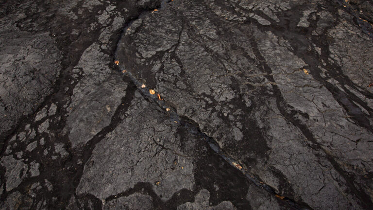 An overhead view of black oil sands.