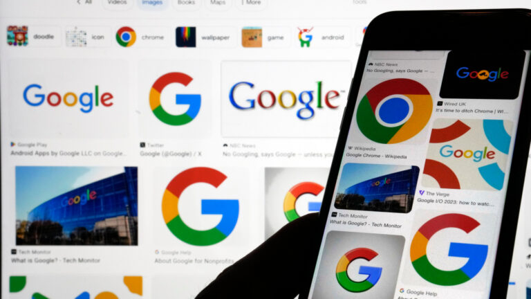 Various Google logos are shown on a telephone and on a computer screen in the background. 