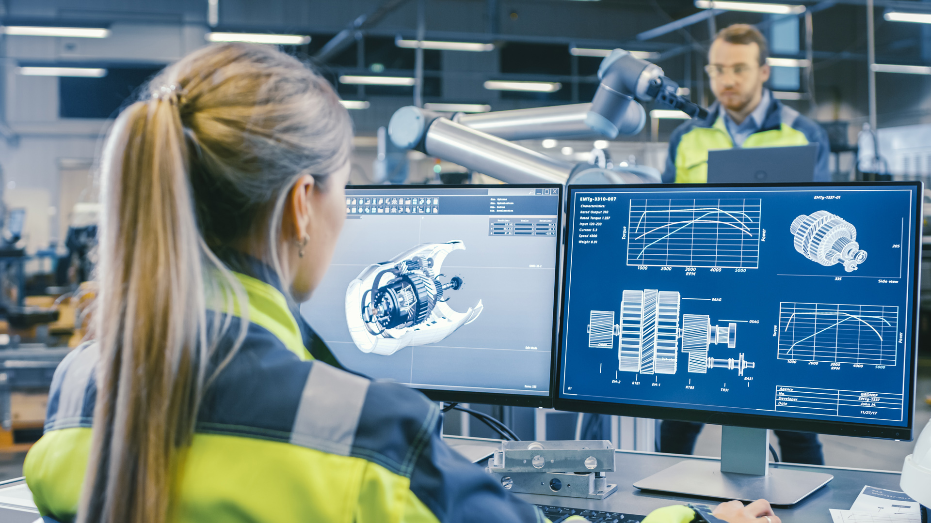 High-tech workers use robotics to build engine parts.