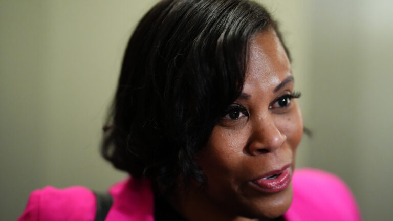 A close-up of Marci Ien speaking to reporters.
