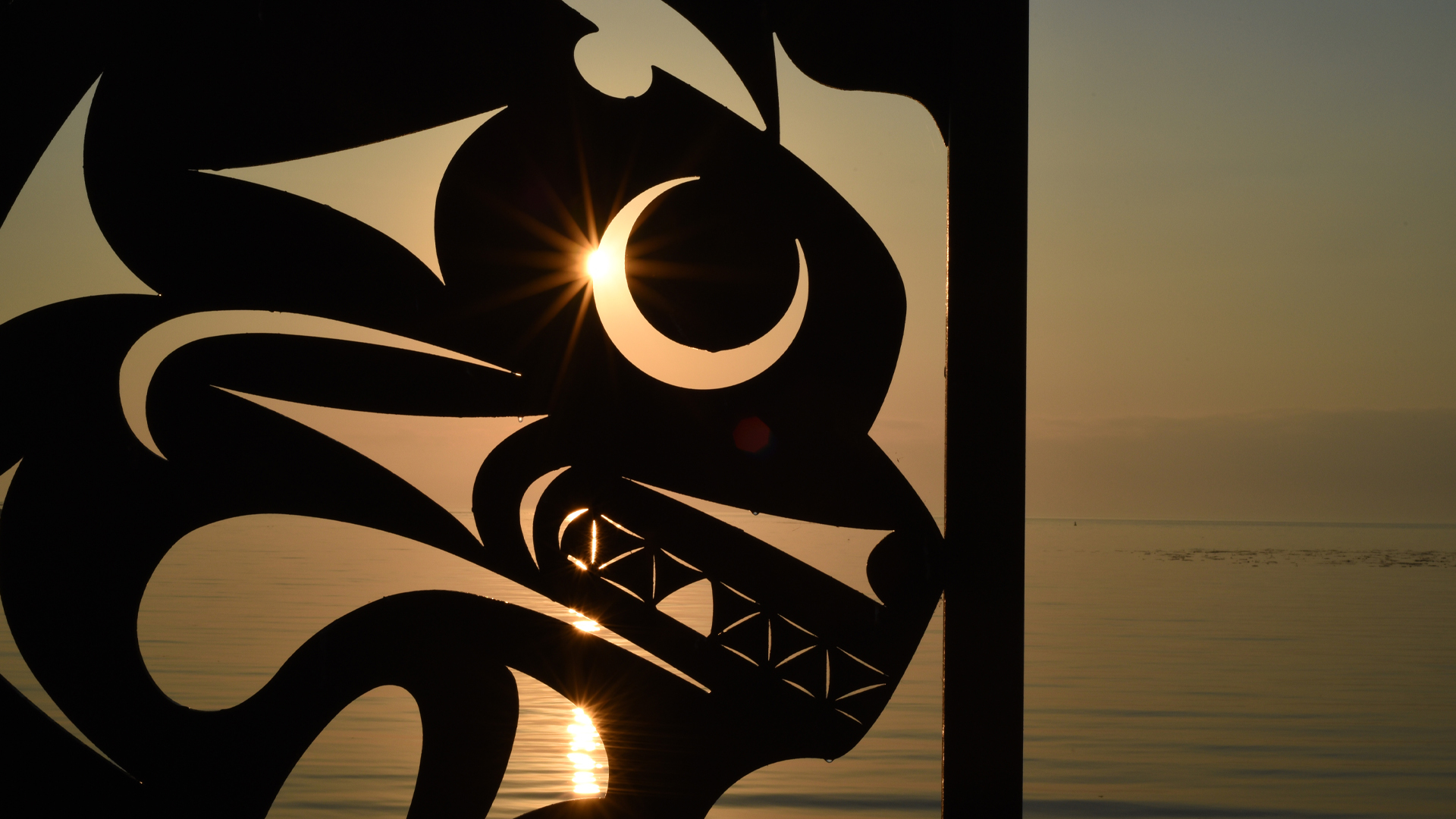 An Indigenous public art sculpture by Chris Paul titled Salish Sea is silhouetted at sunrise along the Oak Bay Marina walkway in the greater Victoria municipality of Oak Bay, British Columbia on Vancouver Island on October 17, 2022. THE CANADIAN PRESS IMAGES/Don Denton