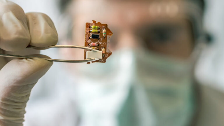 Scientist with an electronic circuit. The COVID-19 pandemic has put science in the spotlight like never before.