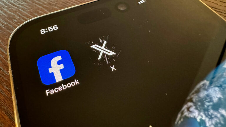 A mobile phone with the Facebook and X app icons.