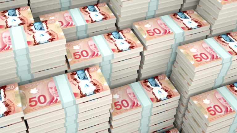 At least a couple dozen $50 bills are stacked in bundles.