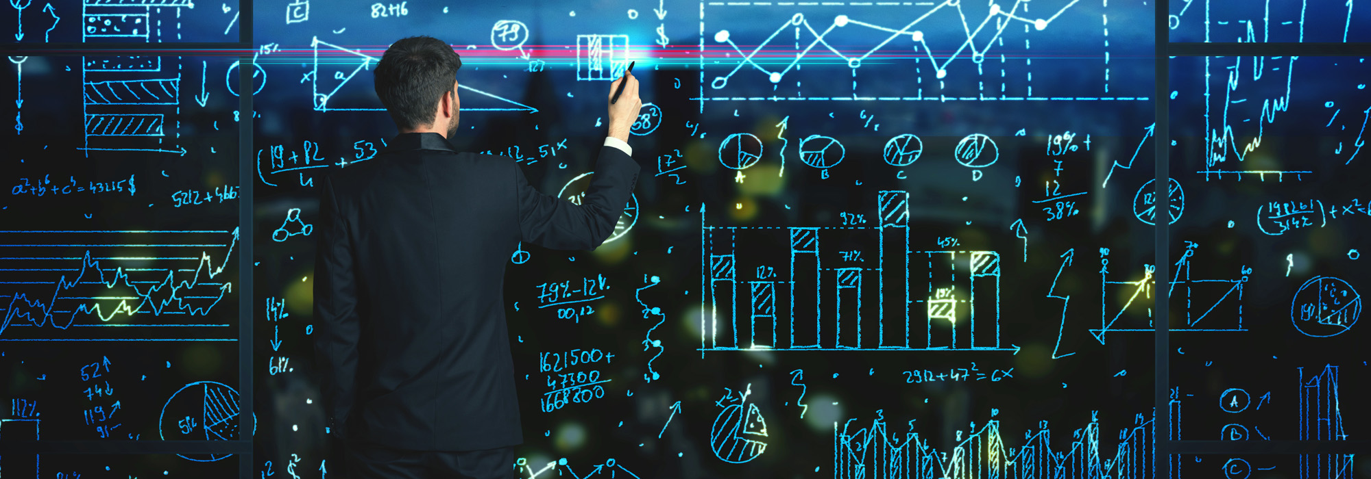 businessman-drawing-business-statistics-on-glass-wall