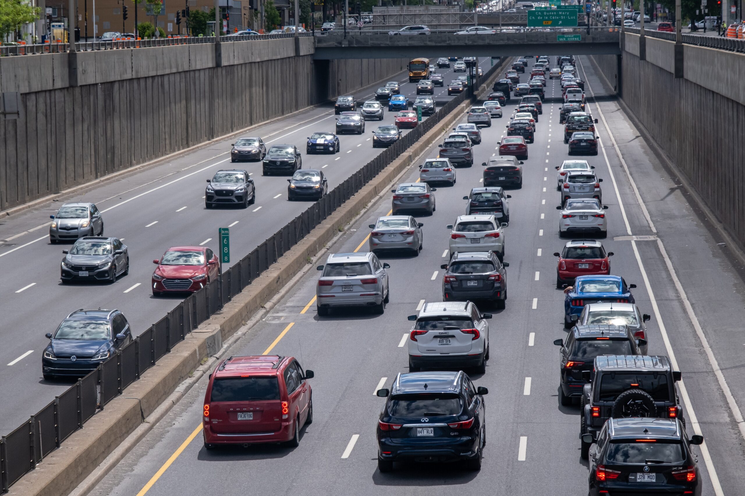 Six lanes of traffic. Four of the lanes are bumper to bumper with vehicles.