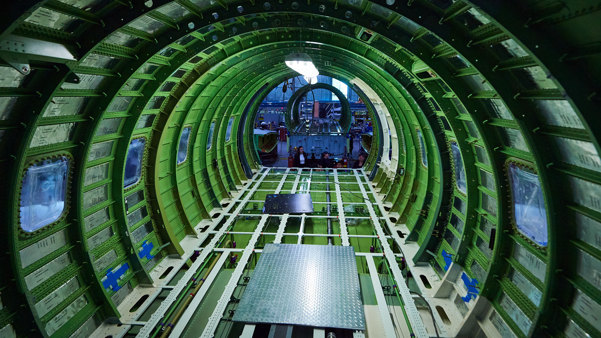 The green inner frame of a fuselage under construction.