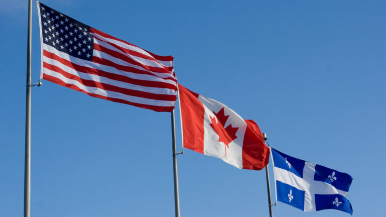 American, Canadian, and Quebec flags fly side by side.