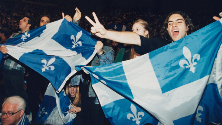 Supporters of Quebec independence wave Quebec flags and make victory signs during a rally in support of sovereignty in Montreal in 1995.