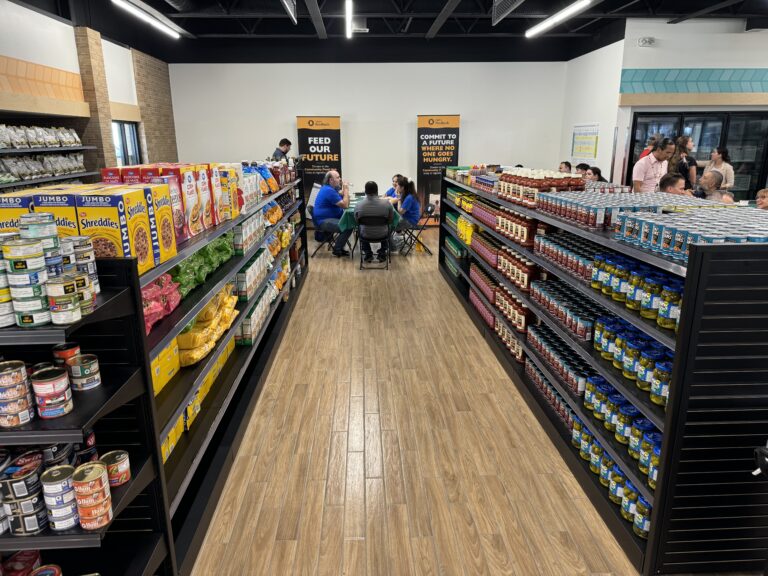 A shiny new foodbank with food organized on shelves with aisles like a supermarket.