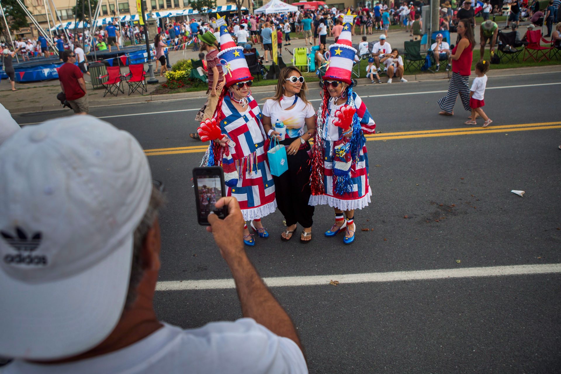 People dress in costumes with blue, red and white. 