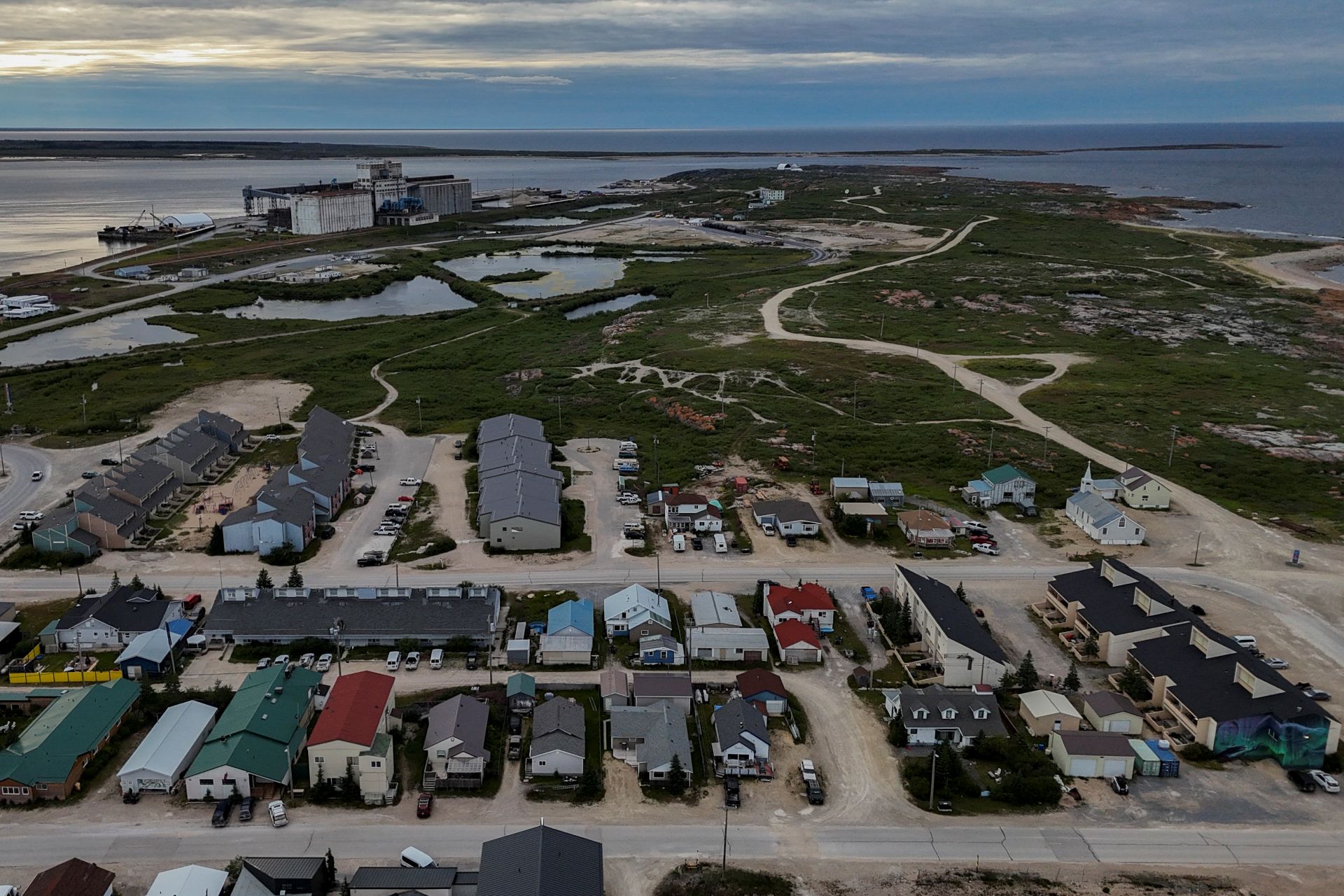 An aerial view of Churchill, Man., with the port and ocean in the background.