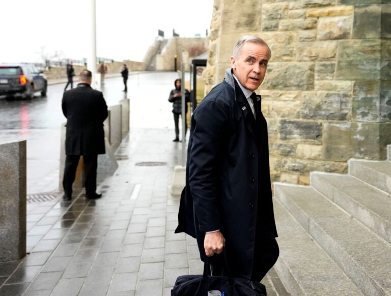 Carney approaches the stone steps at the entrance.