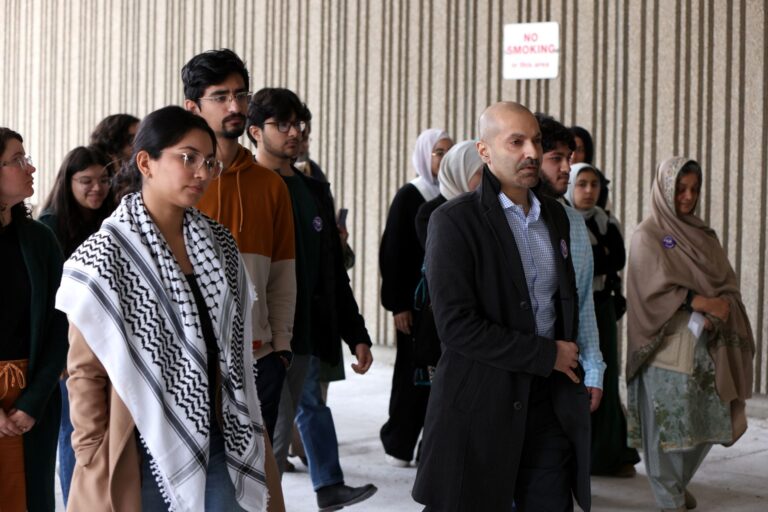 A half dozen family members walking outside a courthouse.