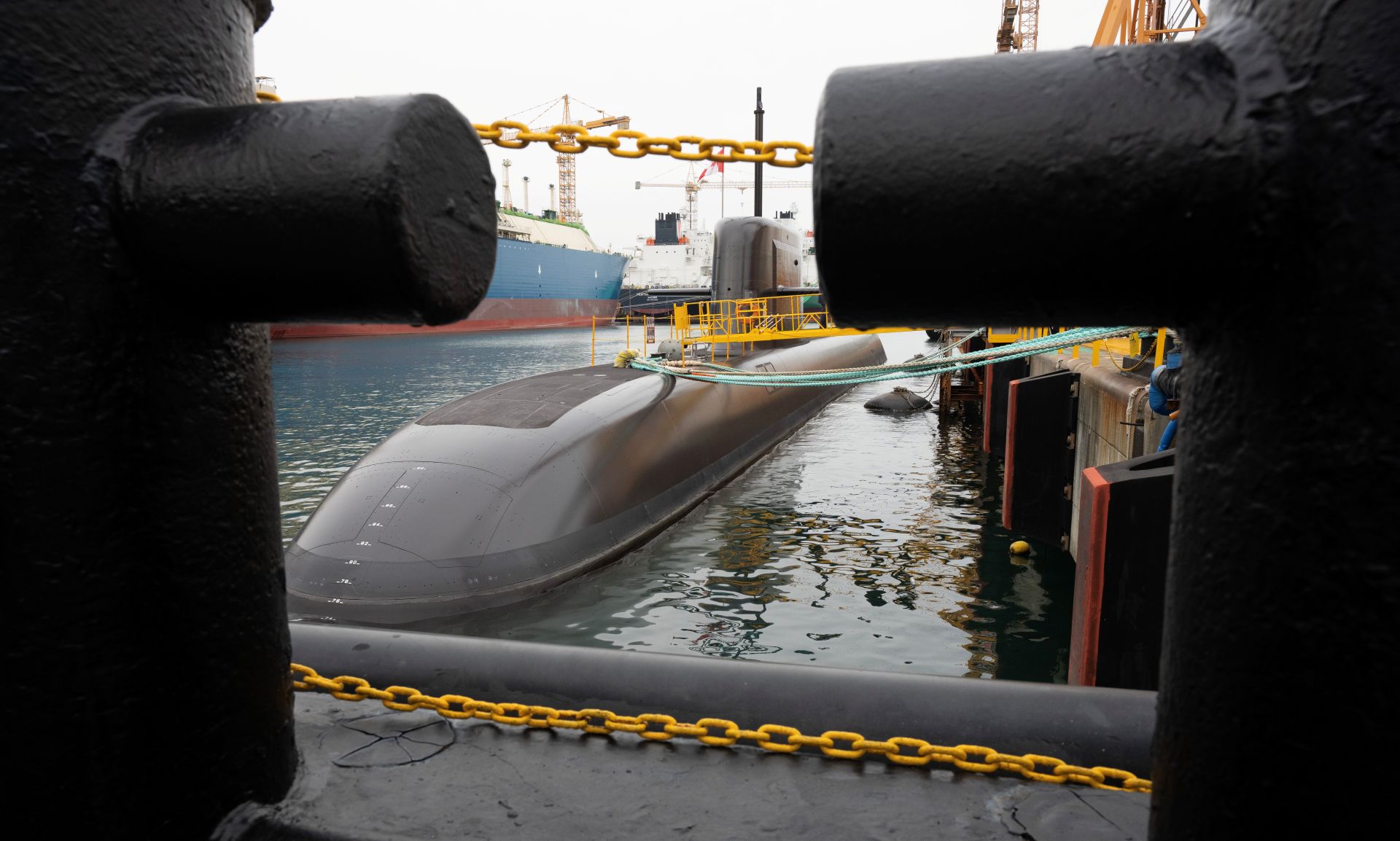 A sub partially submerged, in port. 