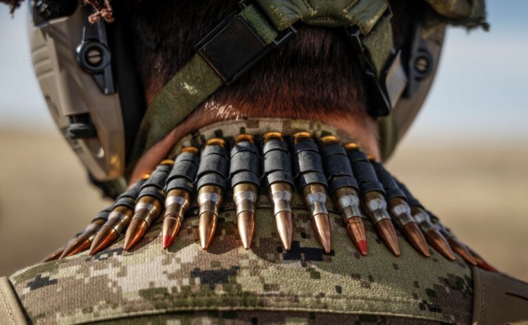 A close-up photo of a belt of ammunition a soldier is carrying around their neck.