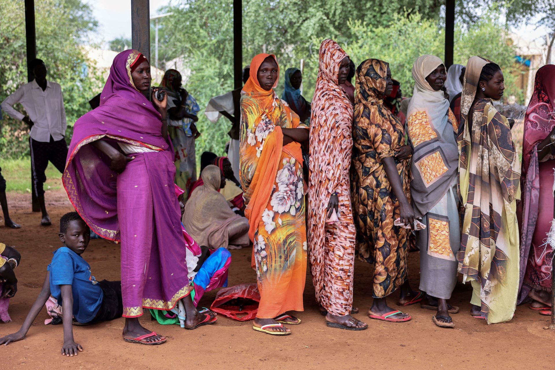 A dozen or so women are lined up outside.