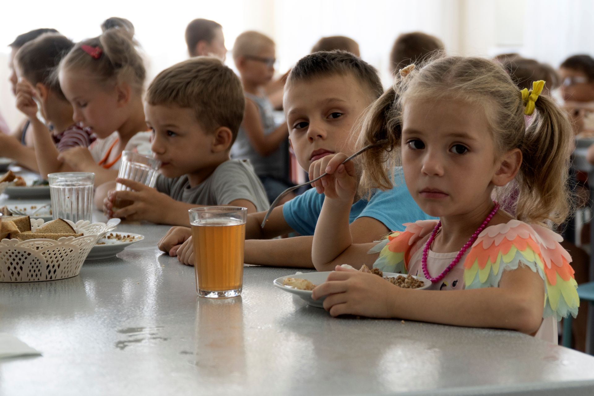 Children from an orphanage in the Donetsk region eat a meal at a camp in southwestern Russia in 2022. Russia was open effort from the outset of the war about plans to adopt Ukrainian children and bring them up as Russian. (AP Photo)