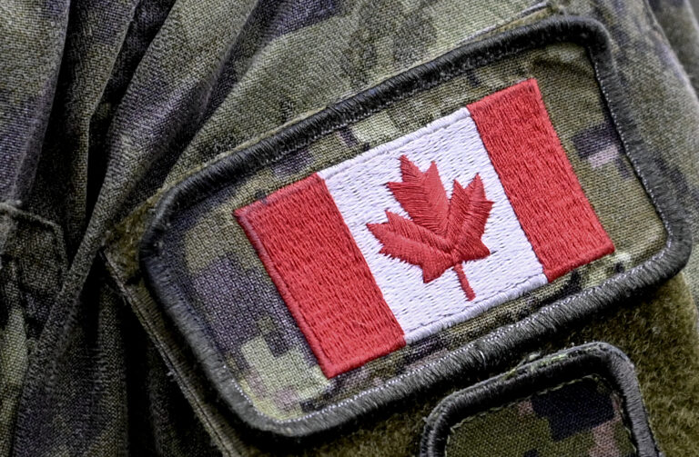 A patch depicting a Canadian flag is sewn on the sleeve.