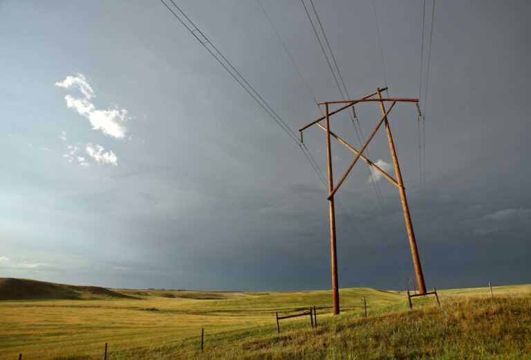 Saskatchewan power line Alt text: Power line runs through the flat Prairie landscape.