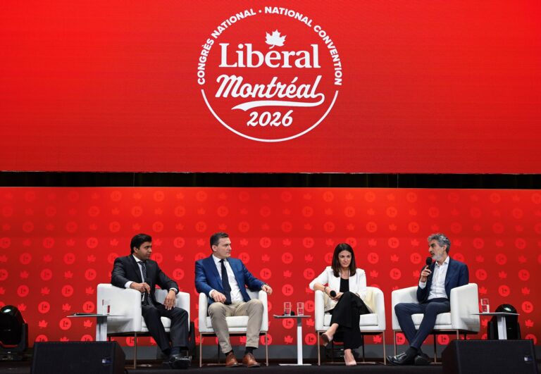 Four people sitting on easy chairs holding microphones on a stage in front of Liberal Party of Canada colours and a logo for their 2026 convention.