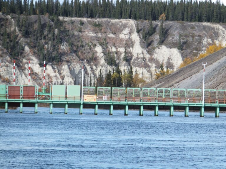 The span is painted turquoise and is surrounded by a rock wall.