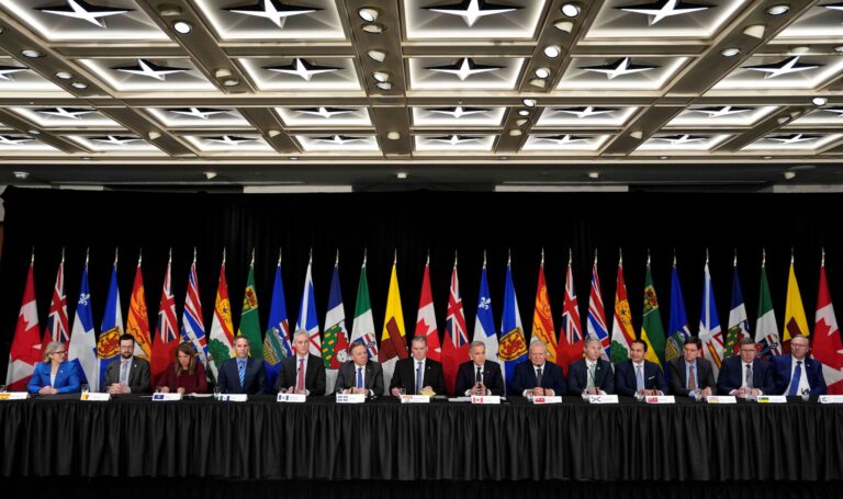 The premiers and PM are seated at one long table.