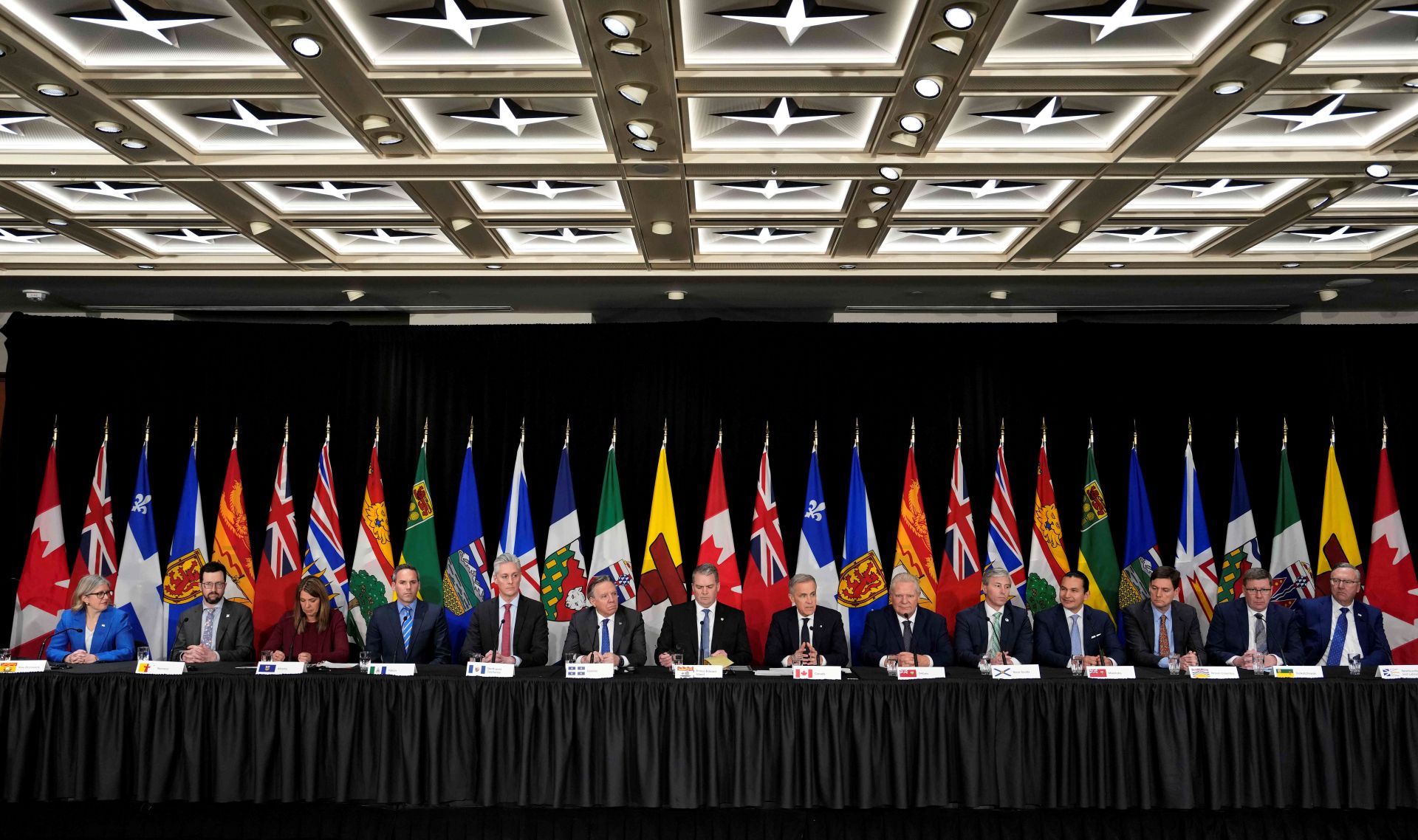 The premiers and PM are seated at one long table.
