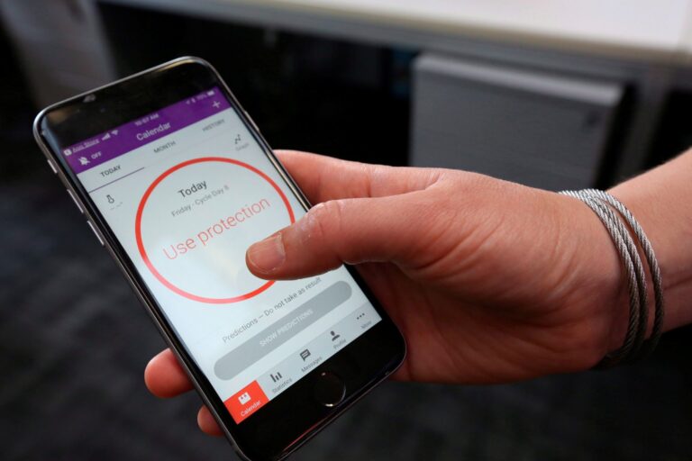 A photo showing a phone with an image of a red circle that says “use protection” in it.