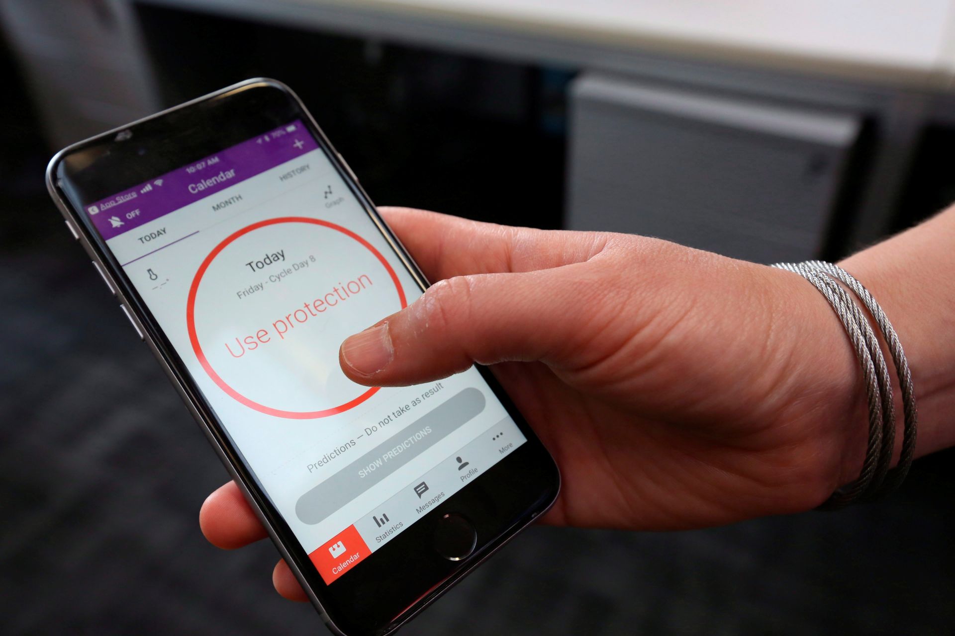A photo showing a phone with an image of a red circle that says “use protection” in it.