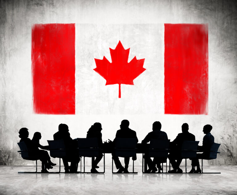 An illustration featuring a dozen people sitting around a table in front of a Canadian flag.