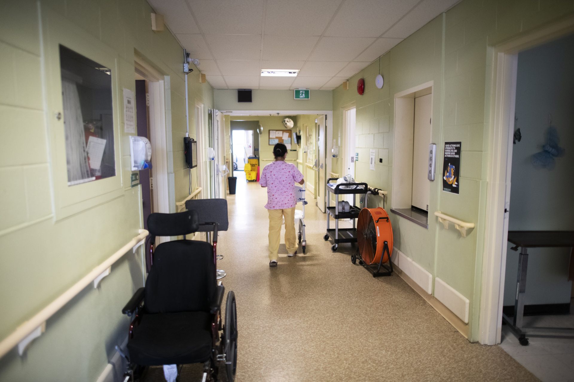 A care worker walks the hall of a long term care home.