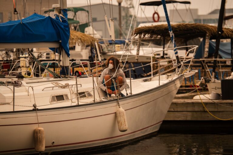A man in a mask works on his sailboat in Toronto.