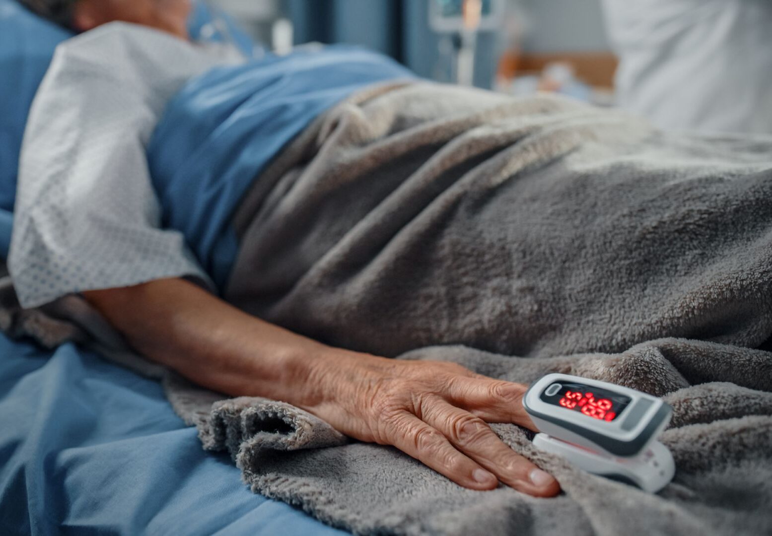 An unidentifiable patient in a hospital bed.
