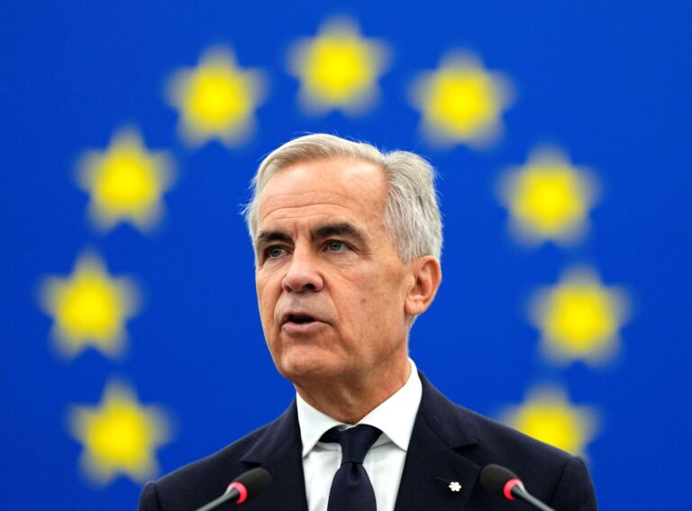 A portrait of Mark Carney surrounded by the yellow stars of the European Union flag.