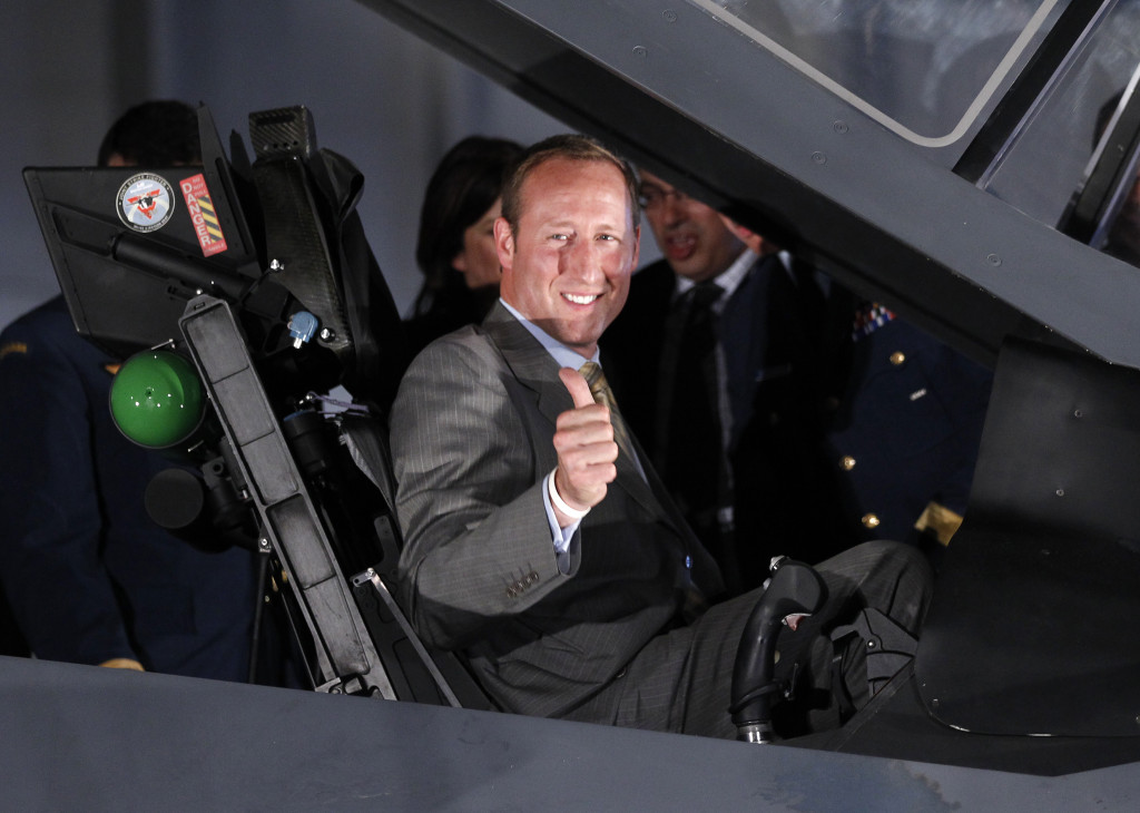 Canada's Defence Minister Peter MacKay gestures while sitting in the cockpit of a mock-up F-35 Joint Strike Fighter during a news conference in Ottawa July 16, 2010. Canada will buy 65 new fighter jets from Lockheed Martin Corp for C$9 billion ($8.6 billion), one of the biggest arms deals in the nation's history, MacKay said on Friday. REUTERS/Chris Wattie (CANADA - Tags: MILITARY POLITICS) - RTR3BJQ3