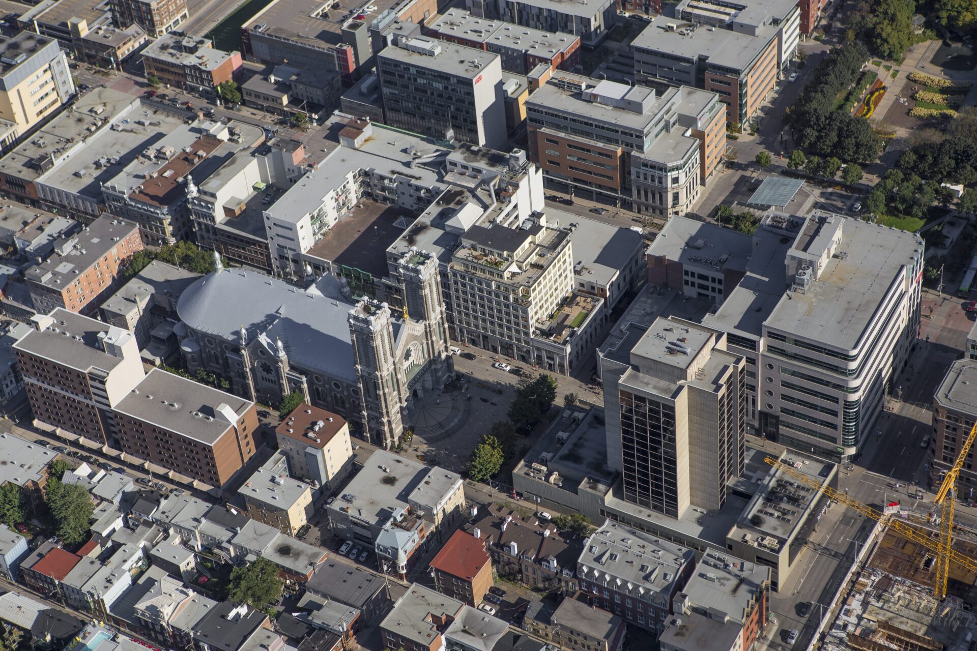 A grid of about seven city blocks shows a mix of flat-topped homes, commercial buildings and a grand church in the middle. 