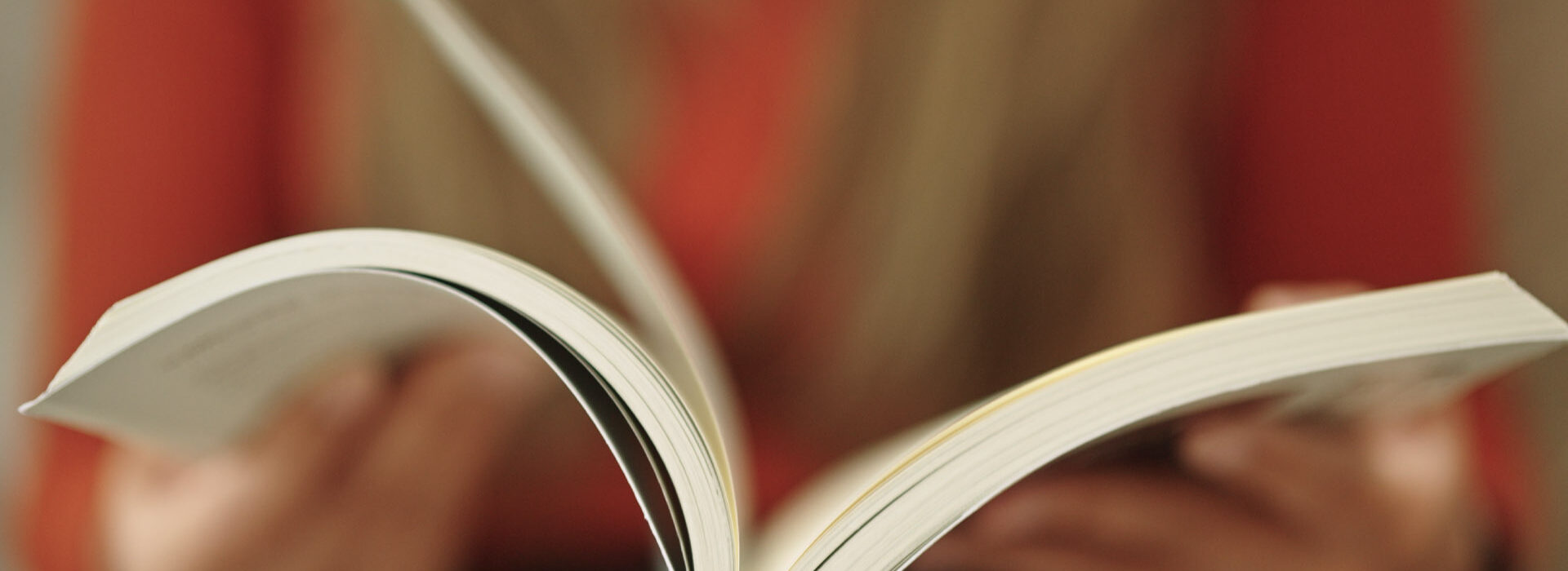 Hands holding a book.