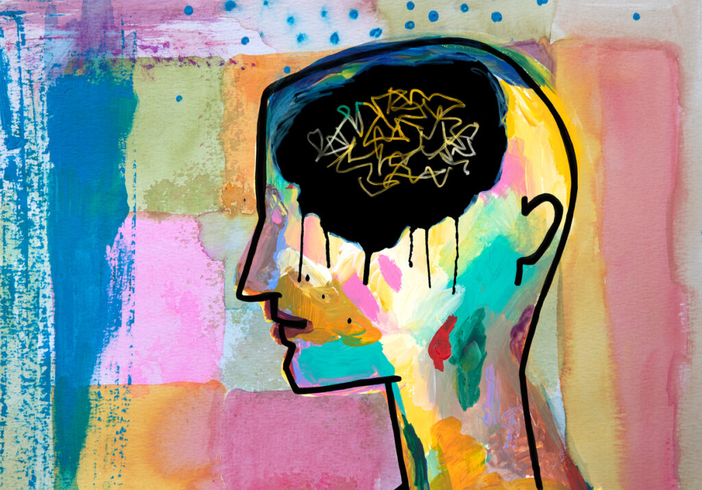 Illustration artistique d’un profil humain coloré sur fond abstrait. La tête est remplie de noir, évoquant la confusion et l’anxiété. 
